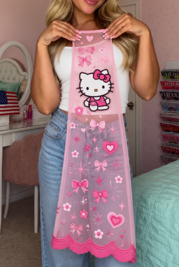 A woman holding up the sheer pink mesh panel of Kitty Jeans: ginger kitten, bows, hearts and daisies, with a scalloped lace hem
